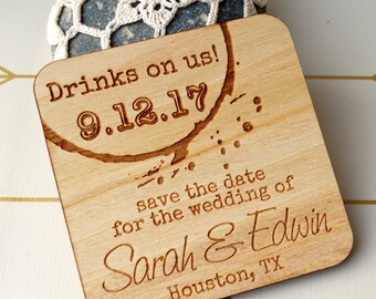 May include: Wooden save the date card with a coffee stain design. The text reads "Drinks on us! 9.12.17 save the date for the wedding of Sarah & Edwin Houston, TX"