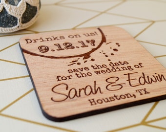 May include: Wooden save the date card with a brown coffee stain design. The text reads "Drinks on us! 9.12.17 save the date for the wedding of Sarah & Edwin Houston, TX"