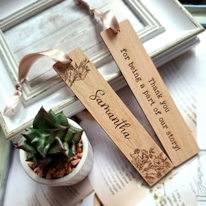 May include: Two wooden bookmarks with floral designs and personalized text. One bookmark says "Thank you for being a part of our story!" and the other says "Samantha".