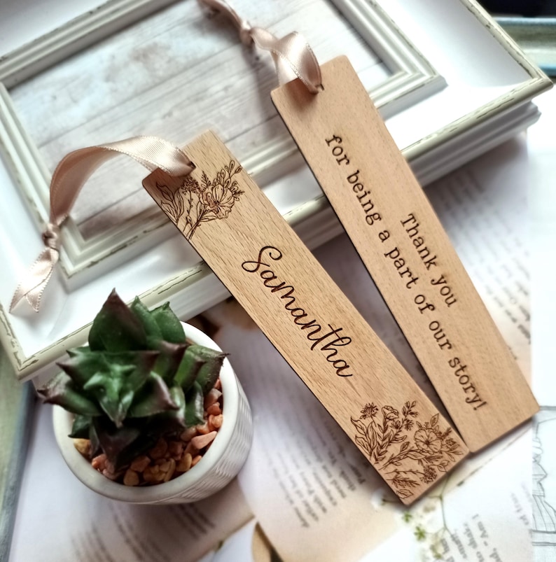 May include: Two wooden bookmarks with floral designs and personalized text. One bookmark says "Thank you for being a part of our story!" and the other says "Samantha".