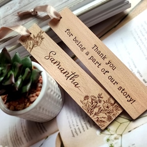 May include: Two wooden bookmarks with a floral design and the text "Thank you for being a part of our story!" and "Samantha".