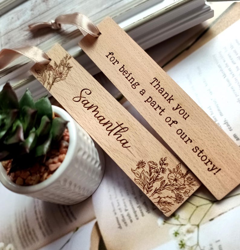 May include: Two wooden bookmarks with a floral design and the text "Thank you for being a part of our story!" and "Samantha".