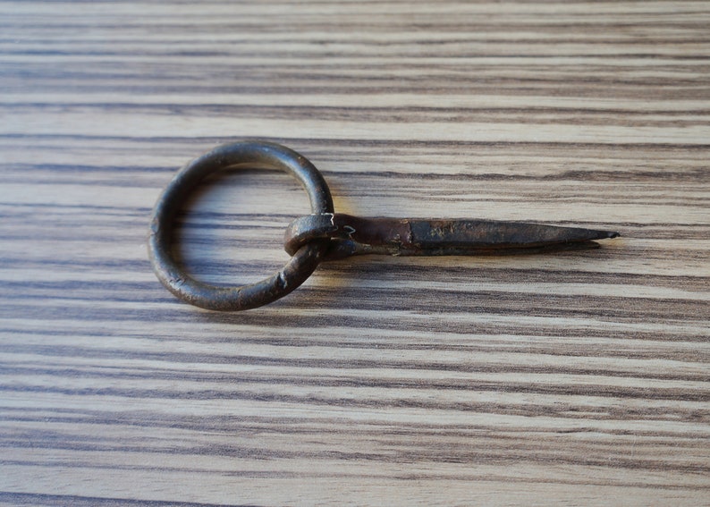 Small hand forged iron split nail for wood with ring for hitching hanging objects vintage architectural salvage for restorations