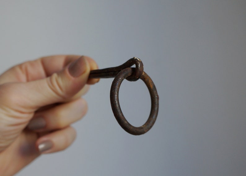 Small hand forged iron split nail for wood with ring for hitching hanging objects vintage architectural salvage for restorations