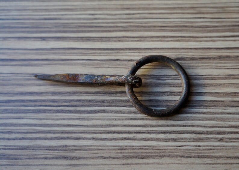 Small hand forged iron split nail for wood with ring for hitching hanging objects vintage architectural salvage for restorations