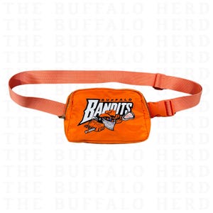 May include: Orange fanny pack with an embroidered logo that says "Buffalo Bandits". The logo features a cartoon bandit holding a lacrosse stick.