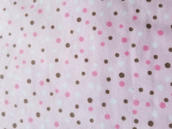 pink blanket with white polka dots