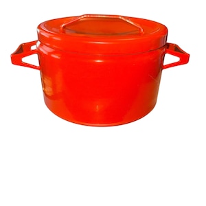 May include: A bright red, cylindrical container with a matching lid and a handle. The container has two side handles and is likely made of plastic or a similar material. The overall design is simple and functional.