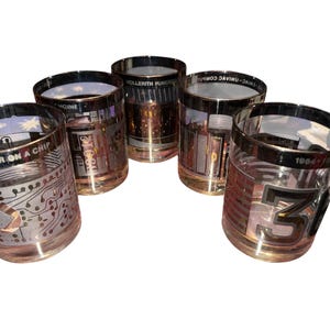 May include: Set of five vintage-style drinking glasses with gold rims. Each glass features a unique design, including circuit board patterns, numbers, and text like "COMPUTER ON A CHIP". The glasses have a clear body and a gold base.