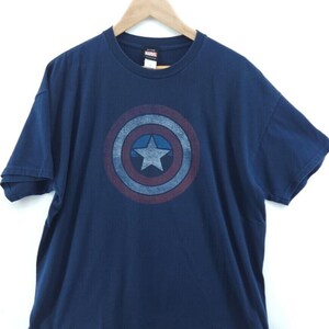May include: A navy blue t-shirt with a vintage-style Captain America shield graphic on the front. The shield is red, white, and blue with a white star in the center. The shirt has a crew neck and short sleeves. The text "MARVEL" is printed on the tag.
