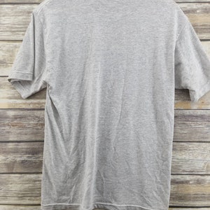 May include: A heather gray short-sleeved t-shirt. The shirt is plain with no graphics or text.