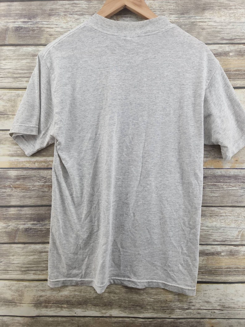 May include: A heather gray short-sleeved t-shirt. The shirt is plain with no graphics or text.