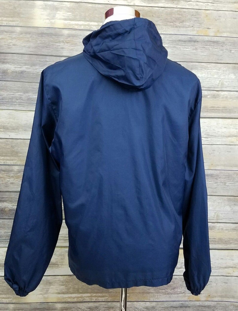 May include: A navy blue hooded jacket with a zipper closure. The jacket is made of a lightweight, water-resistant material.