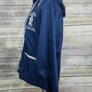 May include: A navy blue windbreaker jacket with white piping and a white embroidered logo that says "Louisiana University".