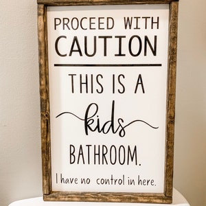 caution this is a kids bathroom sign