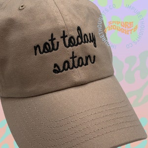May include: A beige baseball cap with black embroidery that reads "not today satan".