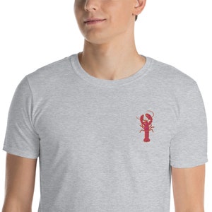 May include: A heather grey t-shirt with a red lobster embroidered on the front.