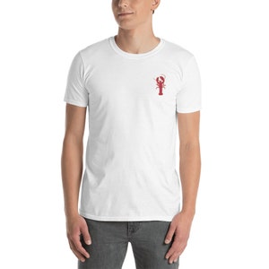 May include: White t-shirt with a red lobster graphic on the front.