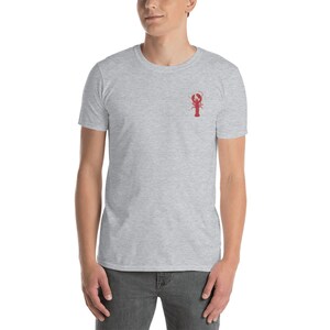 May include: A heather grey t-shirt with a red lobster graphic on the front.