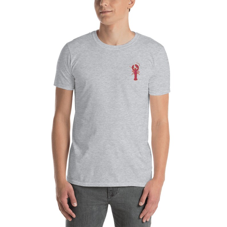 May include: A heather grey t-shirt with a red lobster graphic on the front.