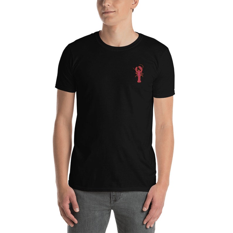 May include: A black t-shirt with a red lobster graphic on the front.