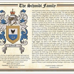 May include: A framed family crest featuring the name "Schmidt" with a detailed coat of arms. The crest includes a shield with an eagle and a hand holding a sword, set against a parchment-like background with decorative borders and text.
