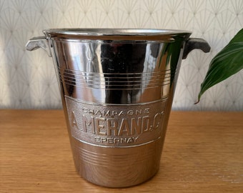 May include: Silver champagne bucket with the words "Champagne A Merand Epernay" embossed on the side.