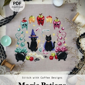 May include: A cross-stitch pattern featuring two black cats with witch hats, a cauldron, potion bottles, apples, and stars. The pattern is titled "Magic Potions" and includes the website "stitchwithcoffee.etsy.com".