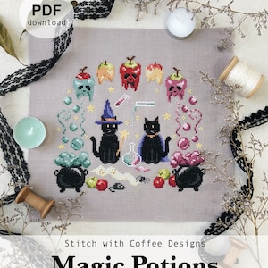 May include: Cross stitch pattern featuring two black cats with witch hats brewing magic potions in cauldrons. The pattern includes apples, spiders, and other Halloween-themed elements. The text "Stitch with Coffee Designs Magic Potions www.stitchwithcoffee.etsy.com" is at the bottom of the pattern.