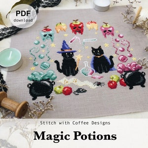 May include: A cross-stitch pattern featuring two black cats, a cauldron, potion bottles, apples, and stars. The text "Magic Potions" is at the bottom of the design. The pattern is available as a PDF download from Stitch with Coffee Designs.
