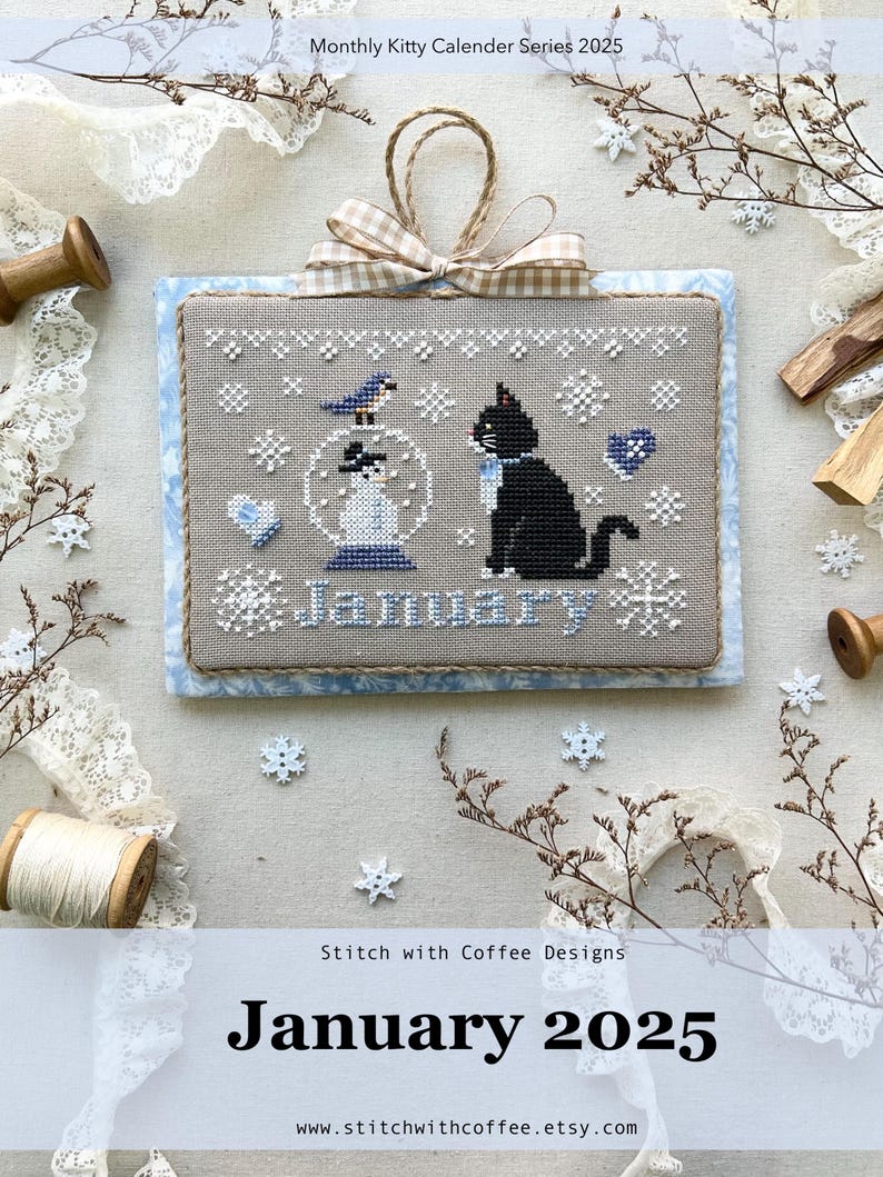 May include: Cross stitch pattern for January from the Monthly Kitty Calendar Series 2025. The design features a black cat, a snowman in a snow globe, and a bluebird. The words "January" are stitched below the design.