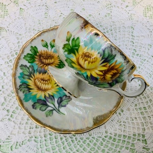 Japan pedestal hand painted teacup and saucer 1950’s.