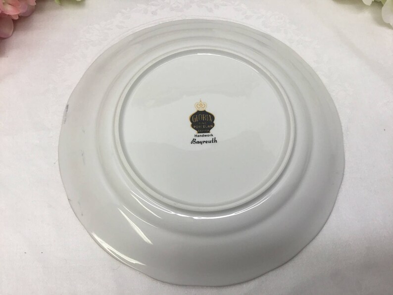 Fine porcelain dessert plate with handle.
