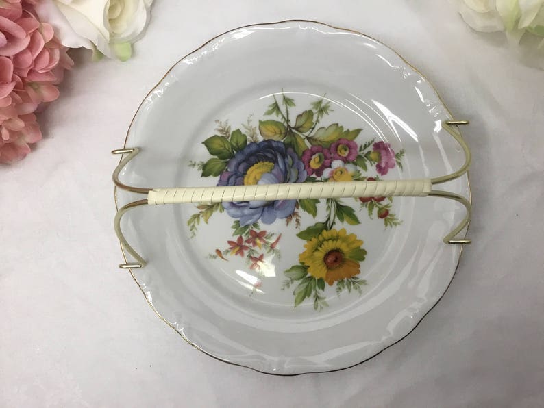 Fine porcelain dessert plate with handle.