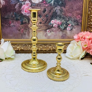 Set of two Baldwin Brass candle sticks.