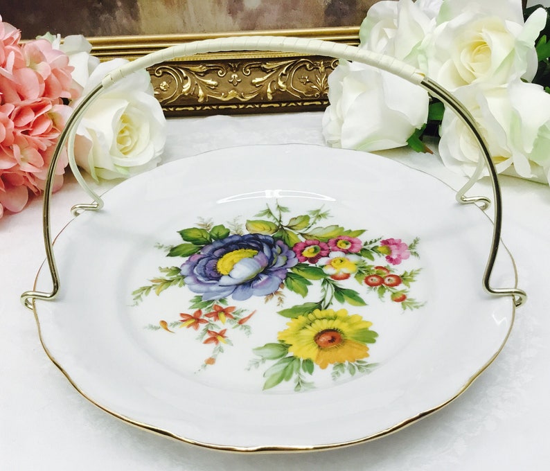 Fine porcelain dessert plate with handle.