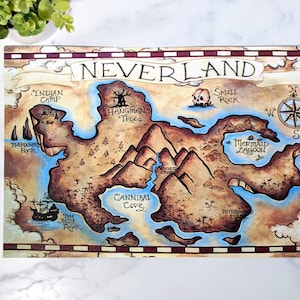 May include: A vintage-style map of Neverland, a fictional island from the Peter Pan stories. The map features various landmarks, including Skull Rock, Mermaid Lagoon, and the Jolly Roger.