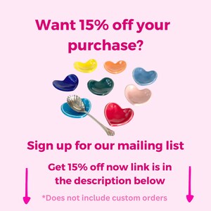 May include: A colourful assortment of heart-shaped ceramic dishes, ideal for serving small treats or condiments. The dishes are arranged in a circle, with a silver spoon resting in one of the dishes. The text "Want 15% off your purchase? Sign up for our mailing list Get 15% off now link is in the description below *Does not include custom orders" is visible at the top and bottom of the image.