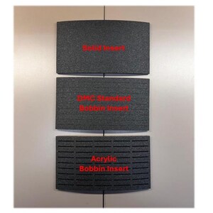 May include: Three rectangular dark gray foam inserts with curved top and bottom edges. The top insert is labeled Solid Insert, the middle is labeled DMC Standard Bobbin Insert, and the bottom is labeled Acrylic Bobbin Insert in red text.