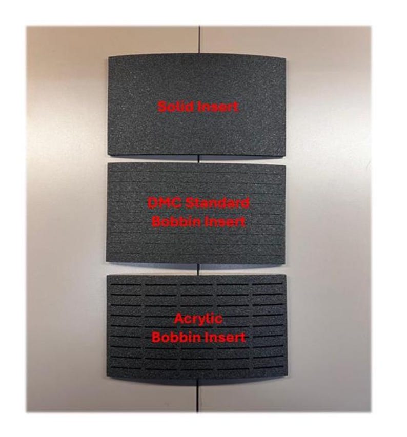 May include: Three rectangular dark gray foam inserts with curved top and bottom edges. The top insert is labeled Solid Insert, the middle is labeled DMC Standard Bobbin Insert, and the bottom is labeled Acrylic Bobbin Insert in red text.