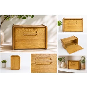 May include: A light oak bread box with a curved top and a recessed handle. The box has a rectangular shape with rounded corners. The wood grain is visible, and the box appears to be new.