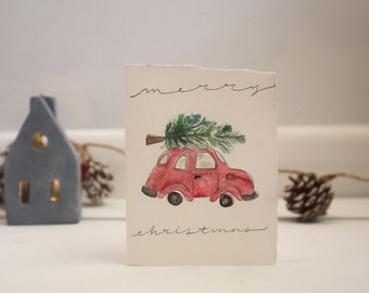 Carte rouge de voiture rouge d’aquarelle de vacances/Noël
