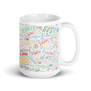 May include: White ceramic mug with a colourful design featuring the words "GEOGEEK", "GIS", "Mapping", "Vector", "Drones", "SQL", "Attribute", and other related terms. The design is a mix of hand-drawn style text and symbols.