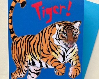 May include: A greeting card with a blue background and a tiger illustration. The card says "Go get 'em Tiger!" in red text.