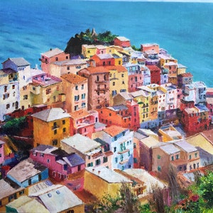 May include: A colourful painting of a seaside town with buildings stacked on top of each other. The buildings are painted in shades of yellow, orange, red, pink, blue, and green. The sea is a bright blue and the sky is a light blue.