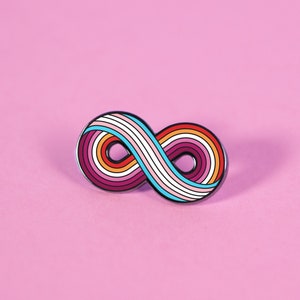 May include: A rainbow infinity symbol pin with a white background. The pin is made of metal and has a black outline.
