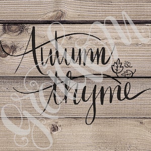 May include: Black and white calligraphy on a wood background reads "Autumn is my time" with a small leaf design to the right of the text.
