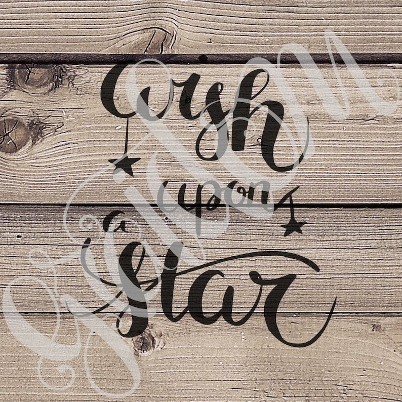 May include: Black and white calligraphy on a wood background that reads "Wish upon a star".