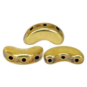 May include: Three gold-coloured crescent-shaped beads with three holes each.