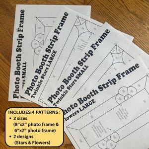 May include: Four white paper templates for a photo booth strip frame, featuring black line drawings of flower and star designs. The text includes Photo Booth Strip Frame, Twinkle Stars, and Flowers in small and large sizes. Includes 8"x2" and 6"x2" sizes.